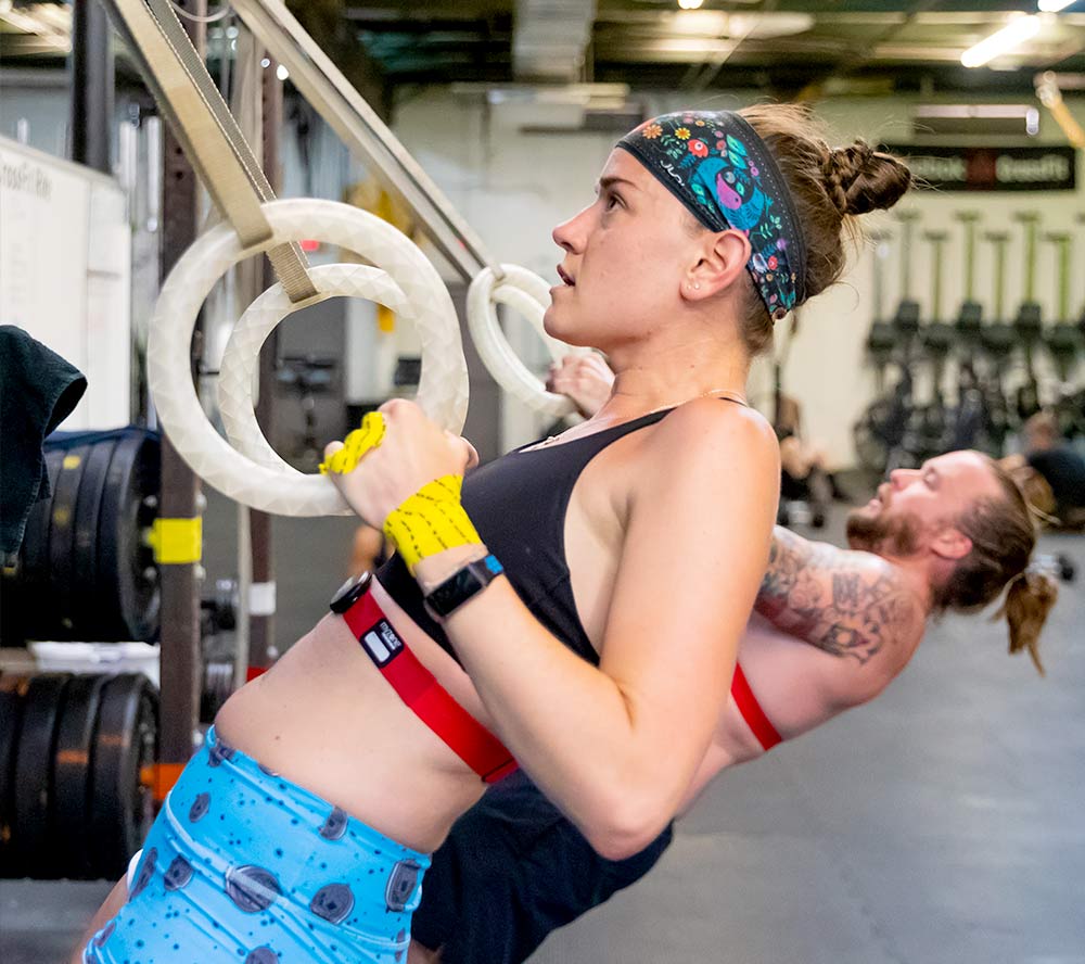 Woman and man working out in the gym.